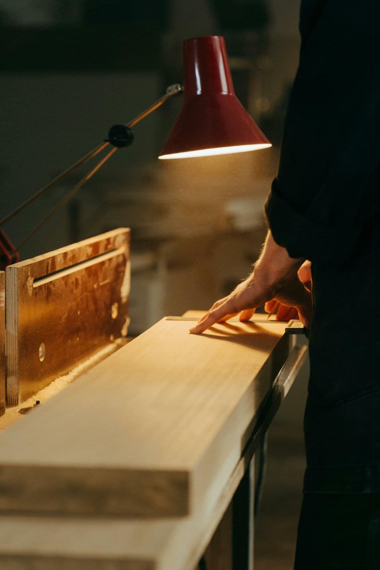 Sean Mullan working on a wooden bench in the joinery workshop